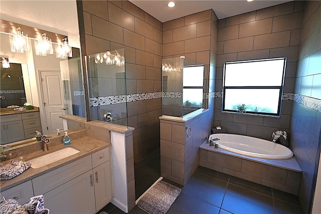 bathroom featuring tile patterned floors, vanity, separate shower and tub, and tile walls