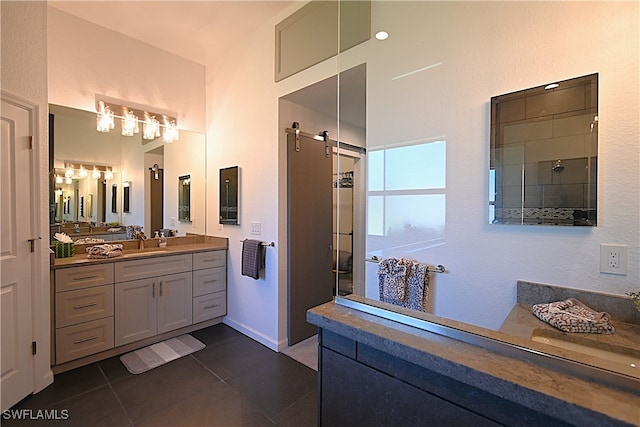 bathroom with tile patterned floors, vanity, and walk in shower