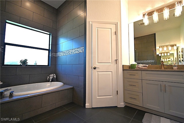 bathroom featuring tile patterned flooring, vanity, a relaxing tiled tub, and tile walls