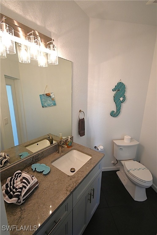 bathroom featuring tile patterned floors, vanity, and toilet