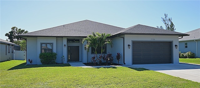 view of front of home featuring a front yard and a garage