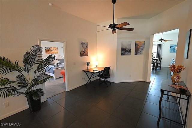 interior space featuring dark tile patterned floors and high vaulted ceiling