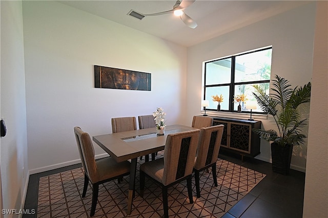 tiled dining room featuring ceiling fan