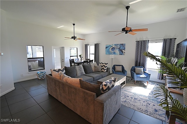 tiled living room with ceiling fan and a healthy amount of sunlight