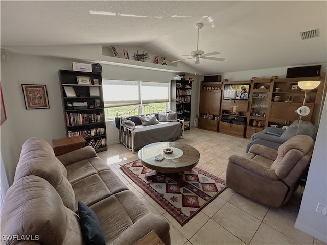 living room featuring ceiling fan, light tile patterned flooring, and vaulted ceiling