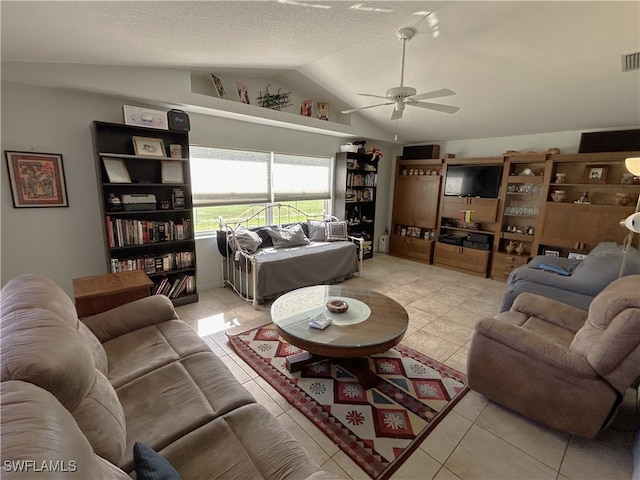 living room with a textured ceiling, vaulted ceiling, ceiling fan, and light tile patterned flooring