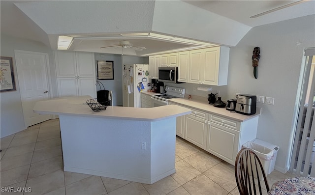 kitchen with white appliances, ceiling fan, light tile patterned floors, white cabinetry, and lofted ceiling