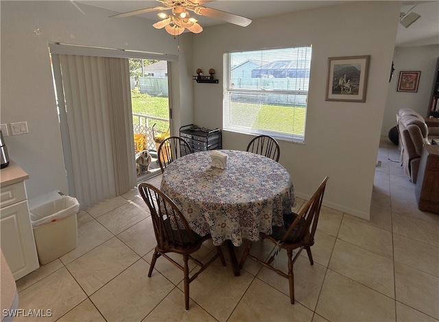 tiled dining room with ceiling fan