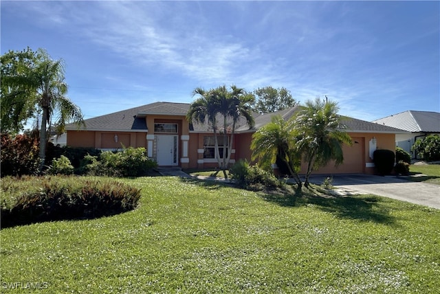 view of front facade featuring a front yard and a garage