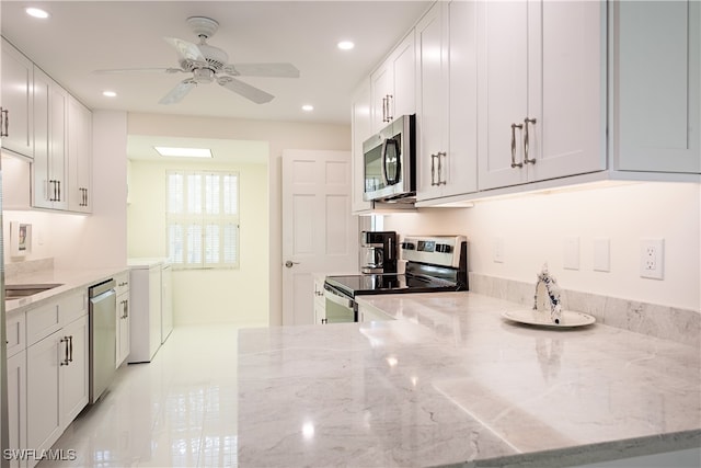 kitchen with white cabinets, ceiling fan, light stone counters, kitchen peninsula, and stainless steel appliances