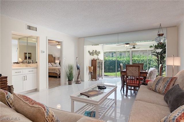 tiled living room with a textured ceiling