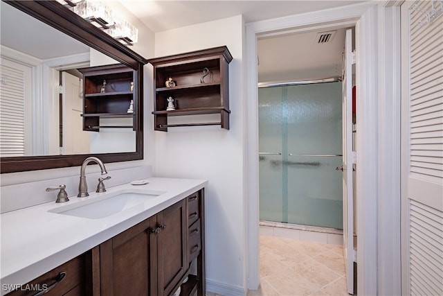 bathroom featuring tile patterned flooring, vanity, and an enclosed shower