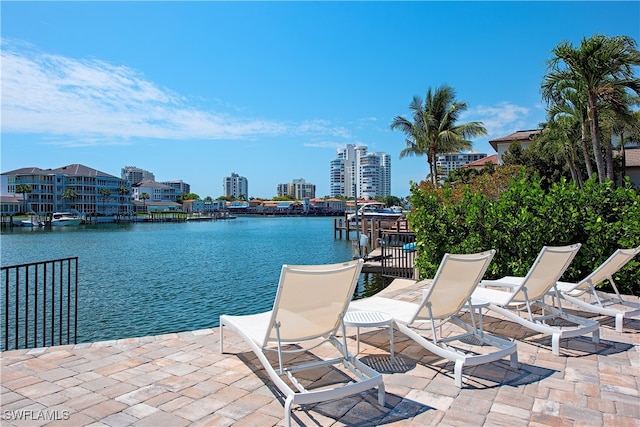 view of patio / terrace featuring a water view and a boat dock