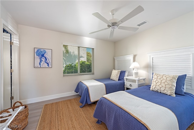 bedroom with ceiling fan and dark wood-type flooring