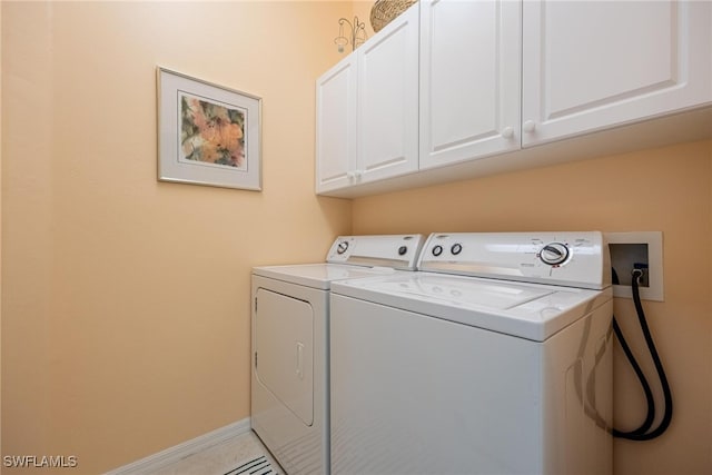 washroom featuring washer and dryer and cabinets