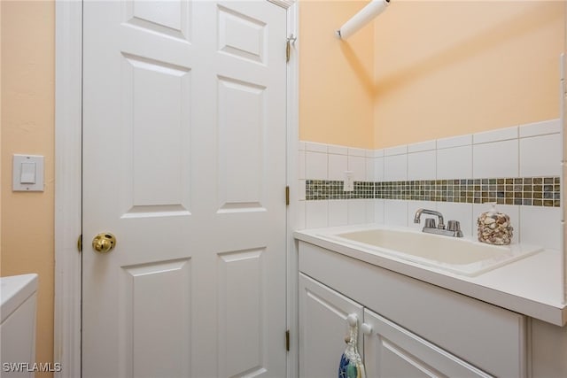 bathroom with vanity and tile walls