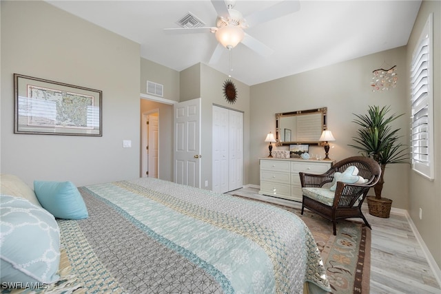 bedroom featuring ceiling fan, light wood-type flooring, and a closet