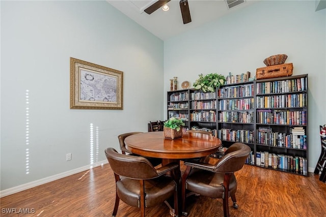 dining space with hardwood / wood-style flooring, ceiling fan, and vaulted ceiling