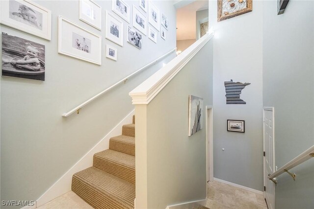 staircase featuring tile patterned floors