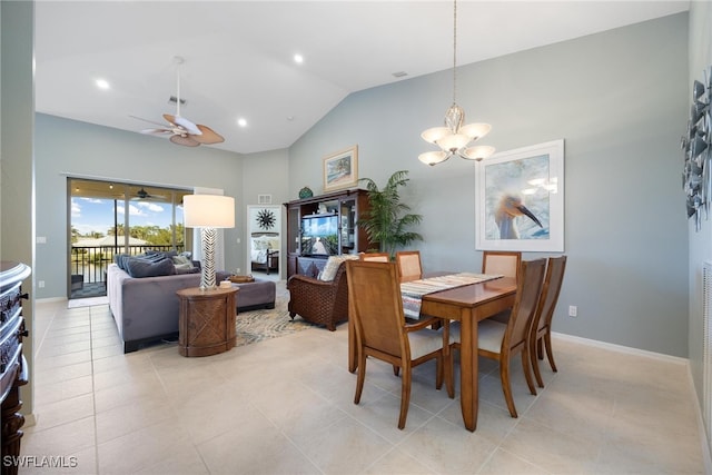 dining area with ceiling fan with notable chandelier, high vaulted ceiling, and light tile patterned flooring