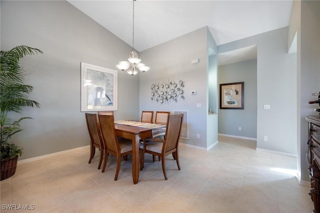 tiled dining space with lofted ceiling and a chandelier