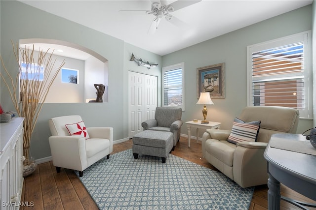 sitting room with dark hardwood / wood-style floors and ceiling fan