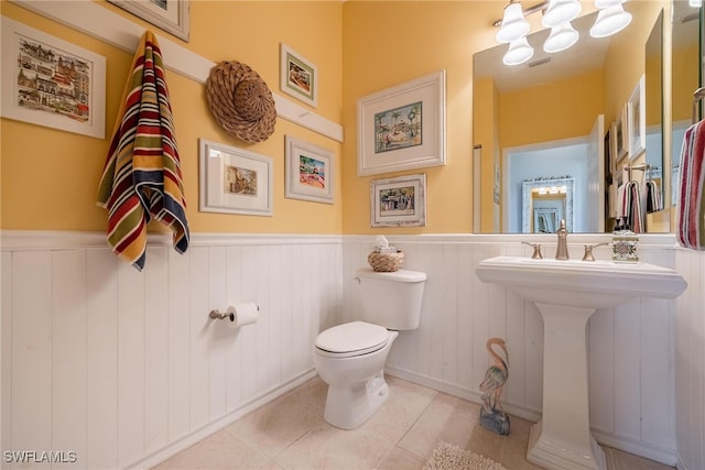 bathroom with tile patterned flooring and toilet