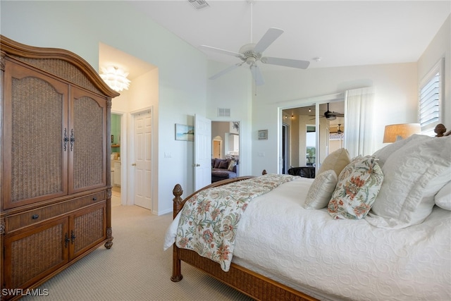 carpeted bedroom featuring ensuite bath, ceiling fan, and lofted ceiling