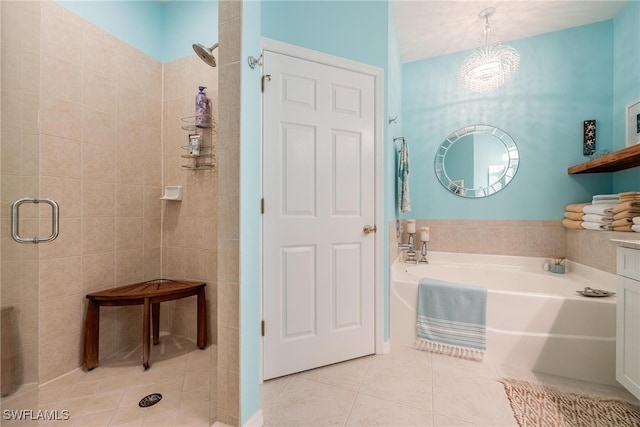 bathroom with tile patterned floors, plus walk in shower, and an inviting chandelier