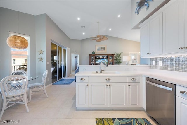 kitchen featuring sink, stainless steel dishwasher, kitchen peninsula, pendant lighting, and white cabinets