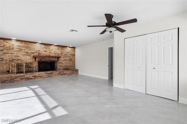 unfurnished living room featuring ceiling fan, brick wall, and a fireplace