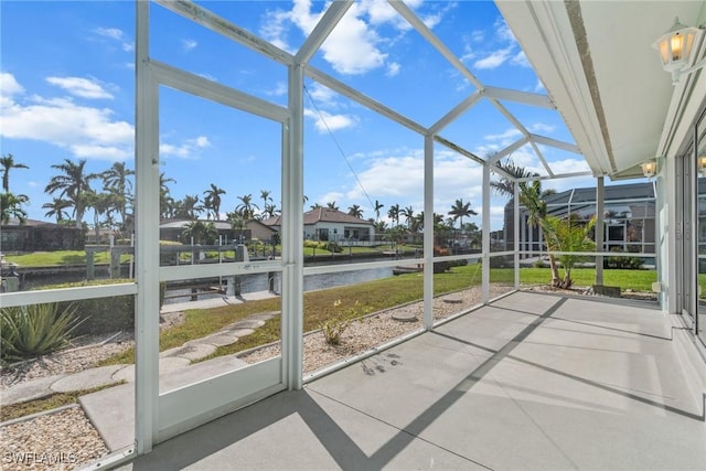 unfurnished sunroom with a water view