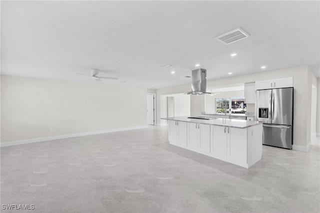 kitchen featuring white cabinetry, stainless steel fridge, island exhaust hood, ceiling fan, and a kitchen island