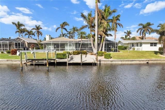 view of dock featuring a residential view, a water view, and a lawn