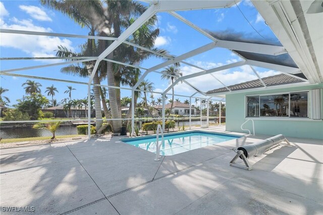 view of pool featuring a lanai, a patio area, and a water view