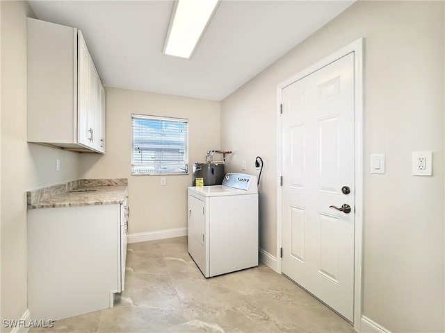 laundry area with water heater, washer / dryer, and cabinets