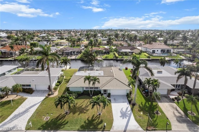 birds eye view of property with a residential view and a water view