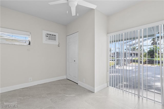 unfurnished room with ceiling fan and a wall mounted air conditioner