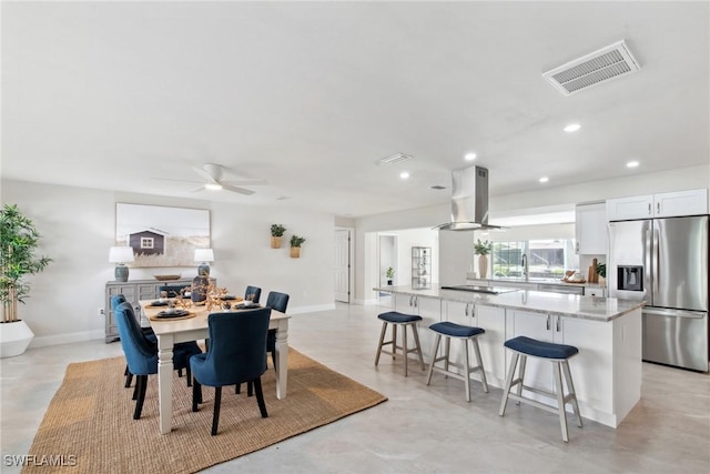 dining space with baseboards, visible vents, a ceiling fan, and recessed lighting