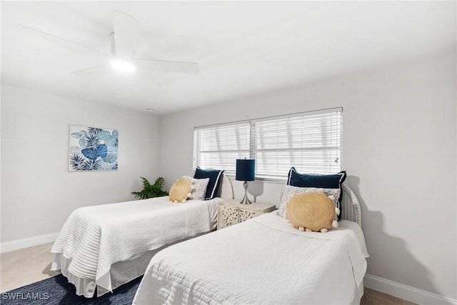 carpeted bedroom with a ceiling fan and baseboards