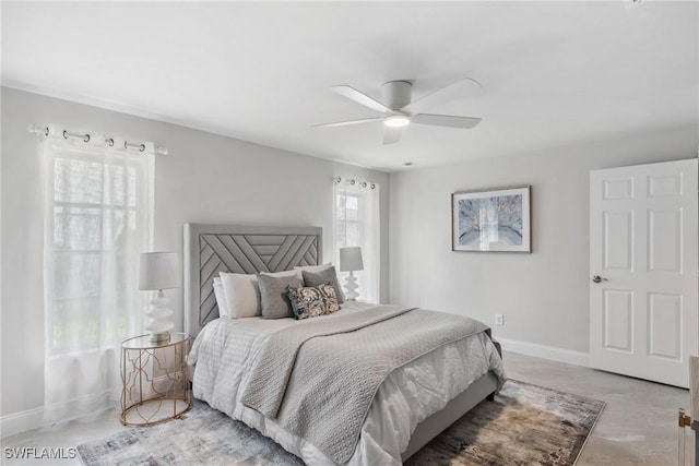 bedroom with ceiling fan and baseboards