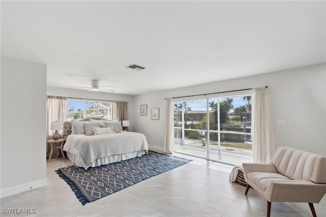 bedroom with access to outside, visible vents, baseboards, and multiple windows