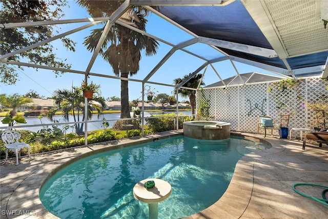 view of pool featuring glass enclosure, a patio area, a water view, and an in ground hot tub