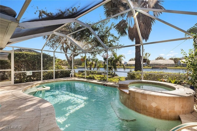 view of pool featuring glass enclosure, an in ground hot tub, and a water view