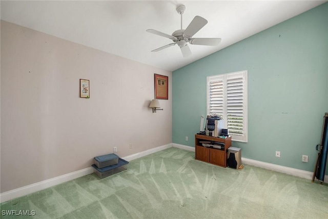 miscellaneous room featuring ceiling fan, light colored carpet, and vaulted ceiling