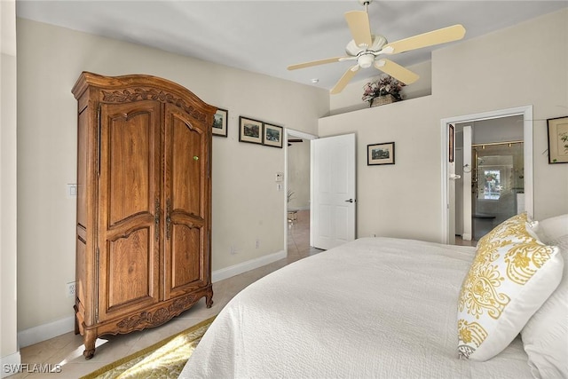 tiled bedroom with ceiling fan and vaulted ceiling