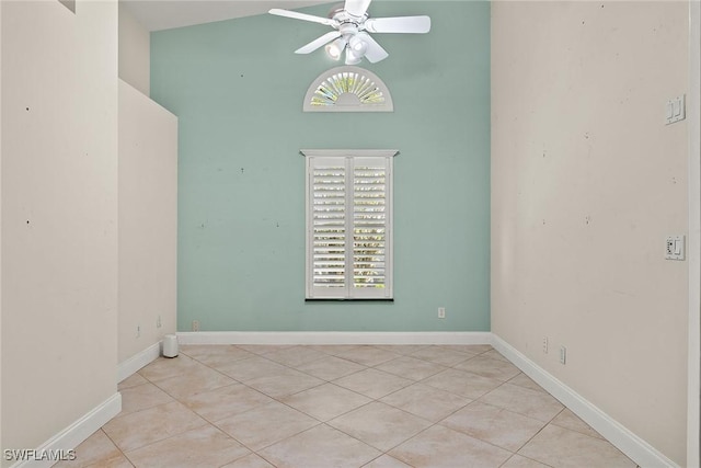 unfurnished room with lofted ceiling, light tile patterned flooring, and ceiling fan