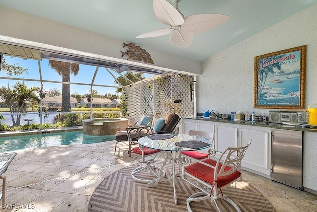 interior space with a water view, vaulted ceiling, sink, and ceiling fan