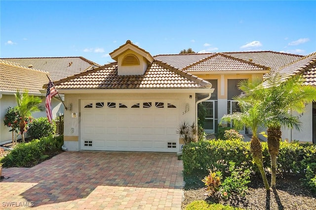 mediterranean / spanish house featuring a garage