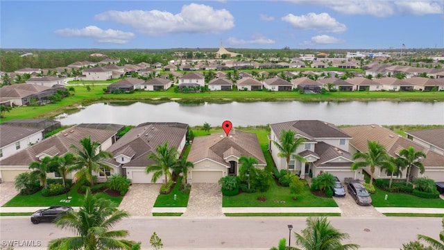 birds eye view of property with a water view